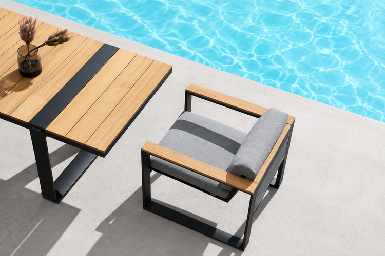 Outdoor furniture set with table and chair by a pool